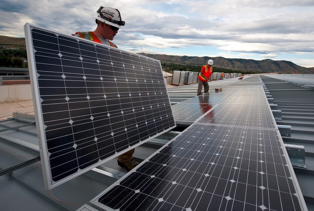 Solar panel installers on a rooftop